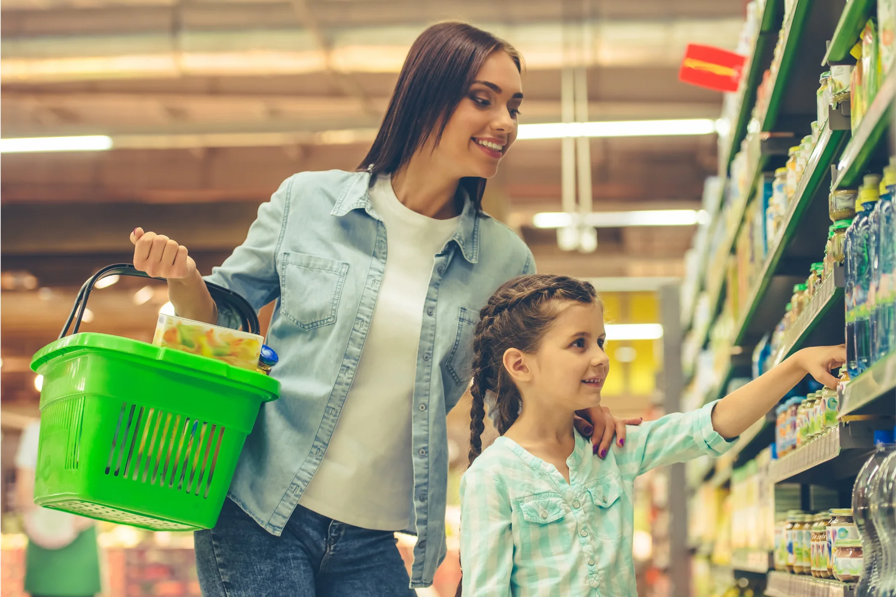 A mother and daughter grocery shopping together