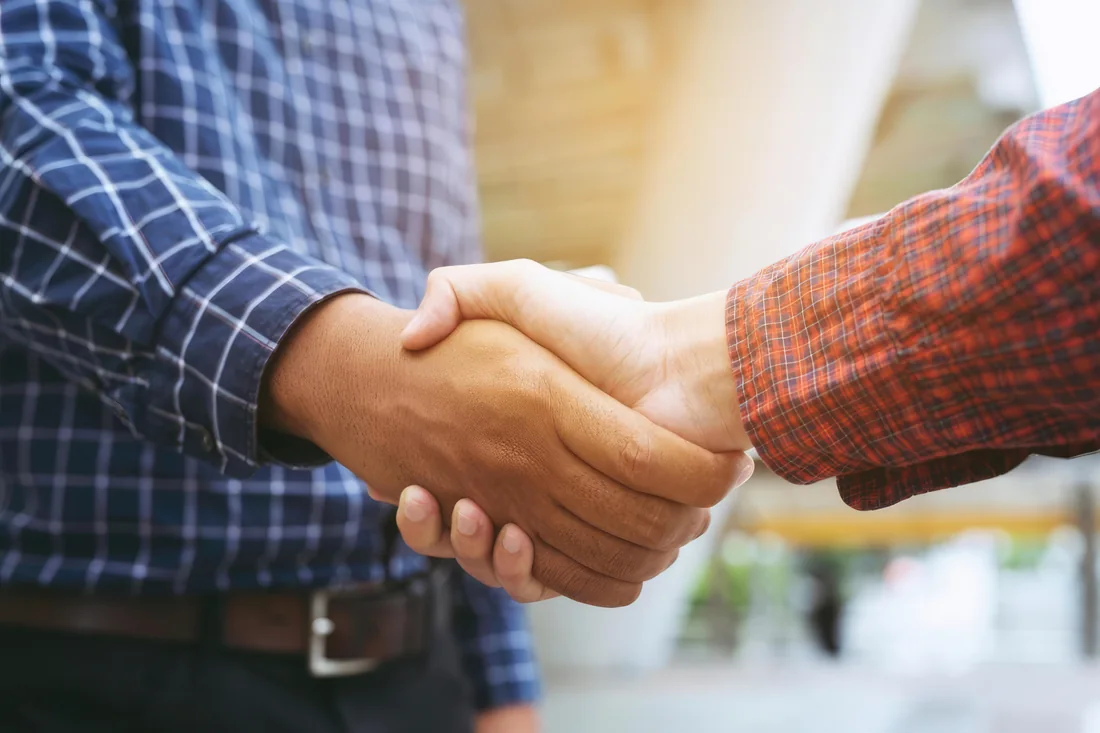 Two people shaking hands in agreement
